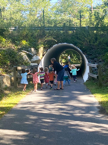 Kids on a hike through a tunnel