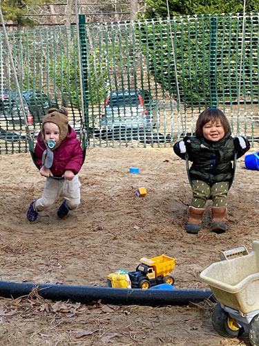 Toddlers on a swing